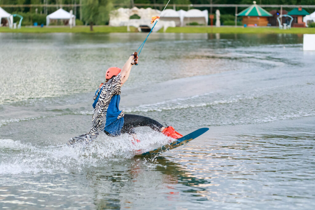 beautiful young girl wakeboarding at lake